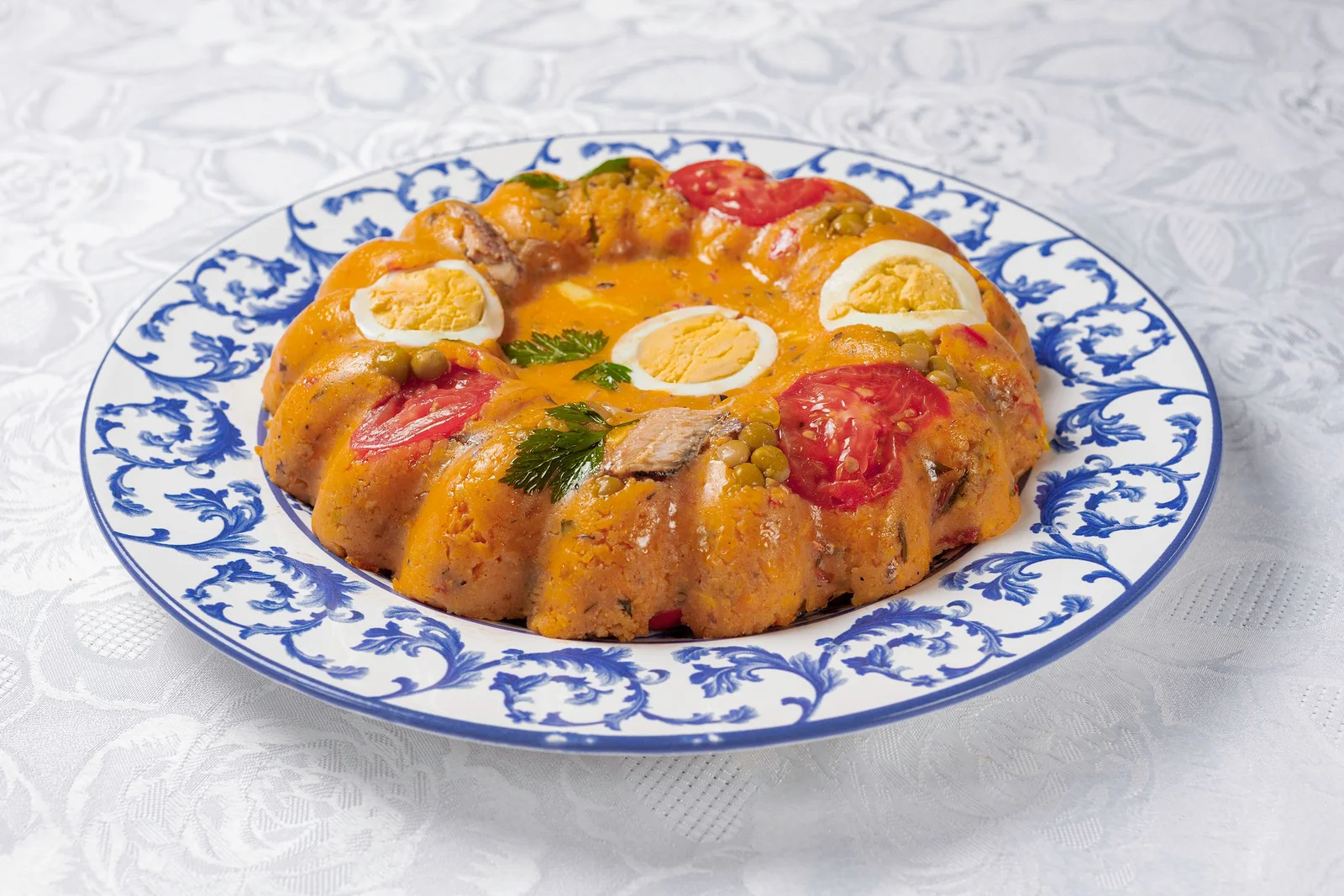 Cuscuz paulista, a savory steamed cornmeal dish with egg, tomato, and peas